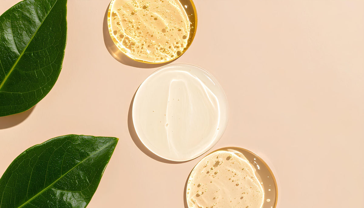 Skincare products styled on a warm neutral surface